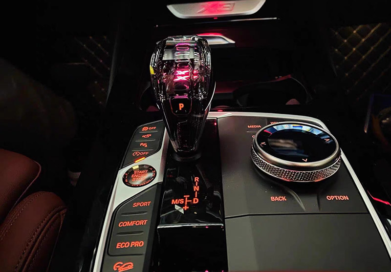 Crystal Shifter with illuminated X logo at night